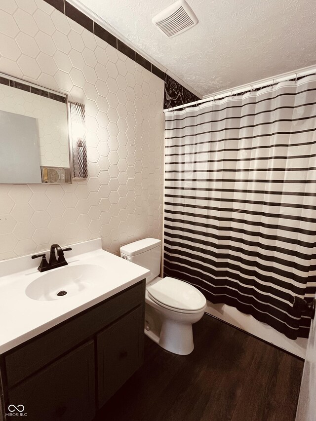 514 W 6th St, Sheridan, IN 46069 - bathroom with tile walls, wood finished floors, vanity, toilet, and a textured ceiling