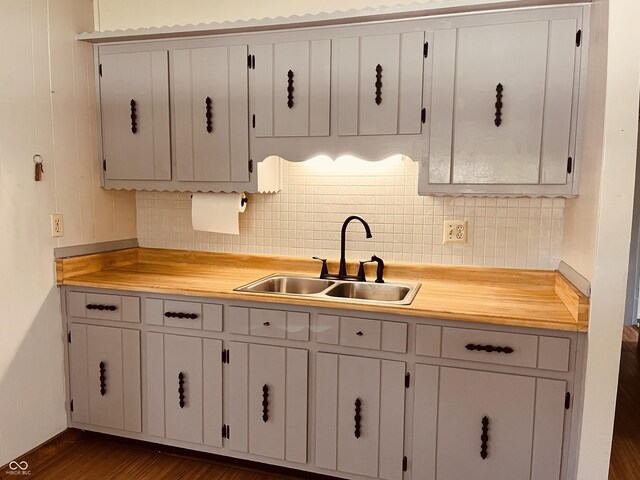 514 W 6th St, Sheridan, IN 46069 - kitchen featuring a sink, tasteful backsplash, and dark wood-type flooring
