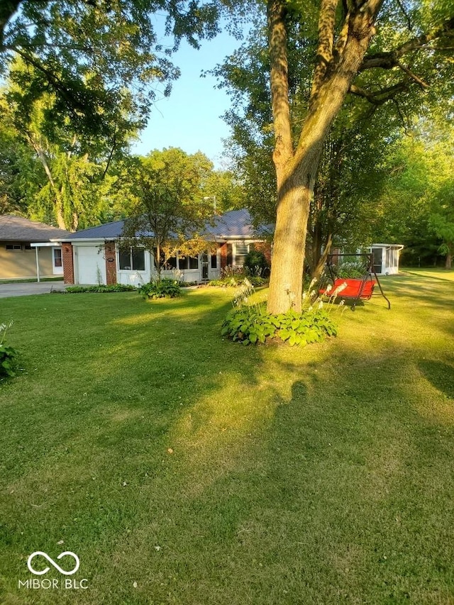 1322 Greenway Dr, Anderson, IN 46011 - view of grassy yard featuring a garage