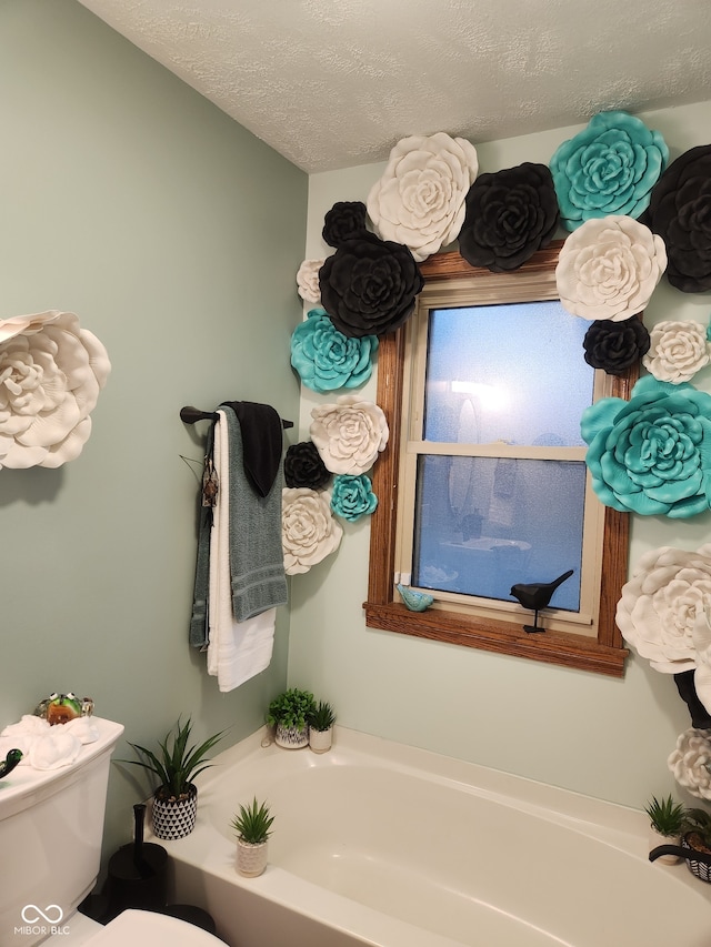 1322 Greenway Dr, Anderson, IN 46011 - full bathroom with a bath, toilet, and a textured ceiling