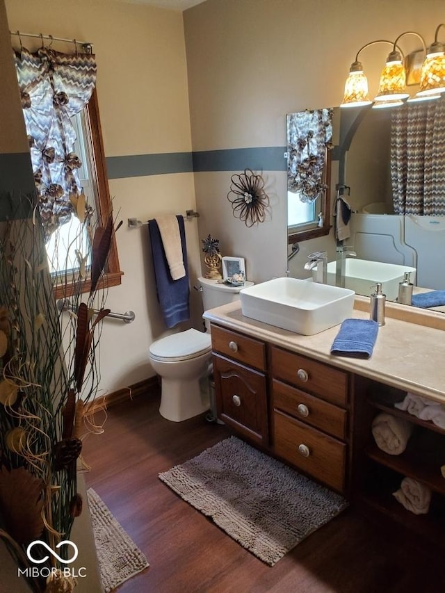 1322 Greenway Dr, Anderson, IN 46011 - bathroom featuring wood finished floors, vanity, toilet, and baseboards