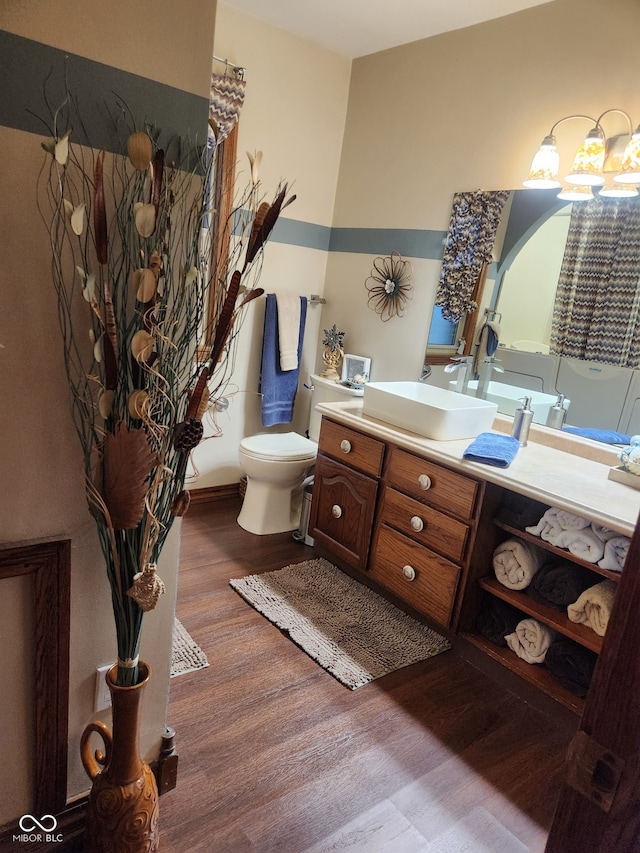 1322 Greenway Dr, Anderson, IN 46011 - bathroom featuring wood finished floors, vanity, toilet, and a chandelier
