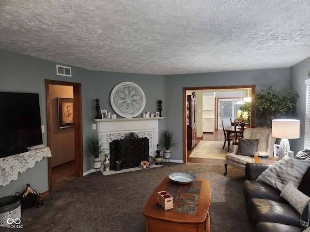1322 Greenway Dr, Anderson, IN 46011 - carpeted living area with baseboards, a fireplace, and a textured ceiling