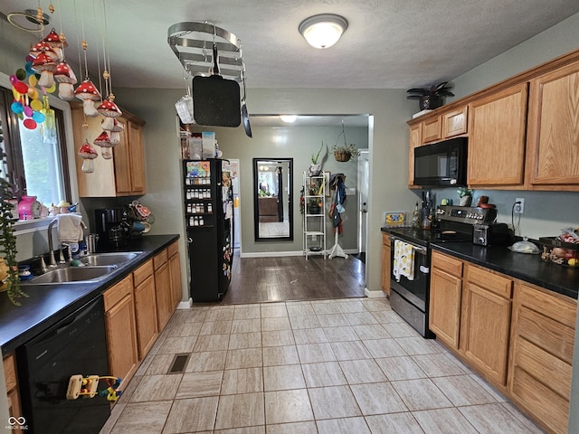 29 Home Ave, Markleville, IN 46056 - kitchen featuring black appliances, dark countertops, a sink, baseboards, and a textured ceiling