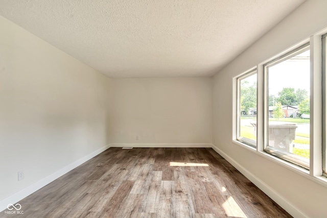 3242 Welch Dr, Indianapolis, IN 46224 - empty room with a textured ceiling, wood finished floors, and baseboards