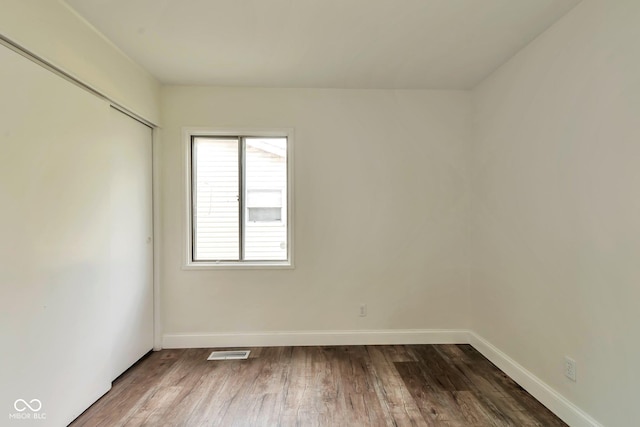 3242 Welch Dr, Indianapolis, IN 46224 - unfurnished bedroom featuring wood finished floors, baseboards, and a closet