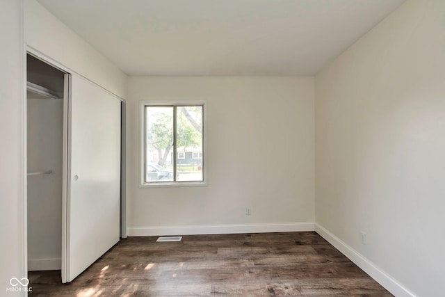 3242 Welch Dr, Indianapolis, IN 46224 - unfurnished bedroom with dark wood finished floors, baseboards, and a closet