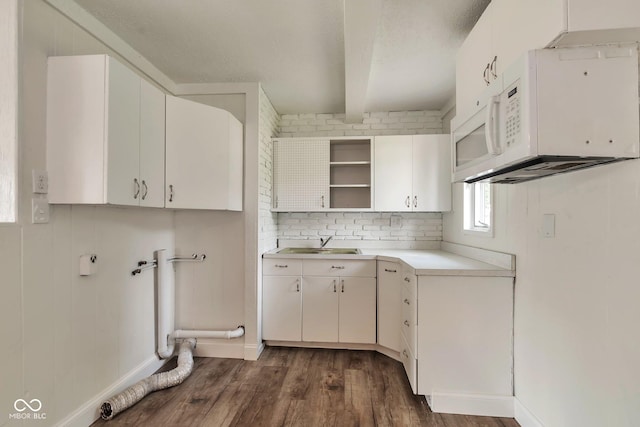 3242 Welch Dr, Indianapolis, IN 46224 - kitchen featuring white microwave, open shelves, dark wood finished floors, white cabinetry, and beam ceiling