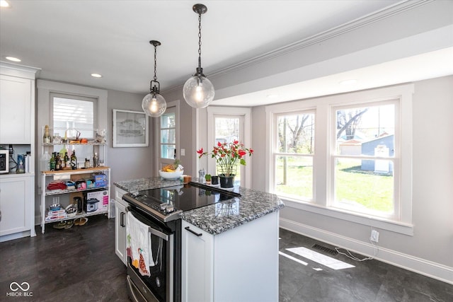 831 Weghorst St, Indianapolis, IN 46203 - kitchen with electric stove, dark stone counters, white cabinetry, recessed lighting, and a center island