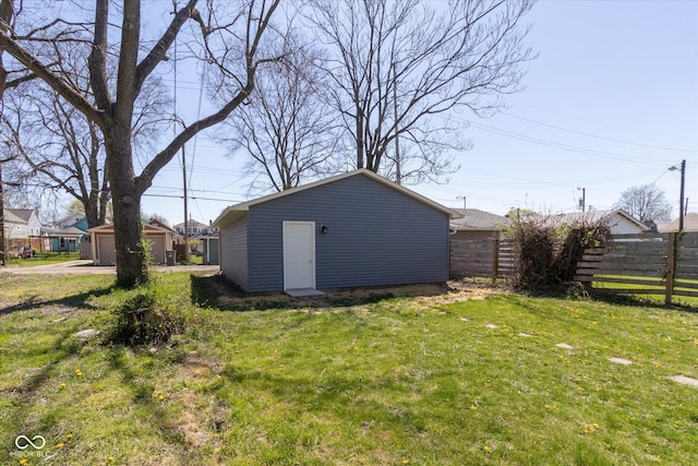 831 Weghorst St, Indianapolis, IN 46203 - view of yard featuring a detached garage and an outdoor structure