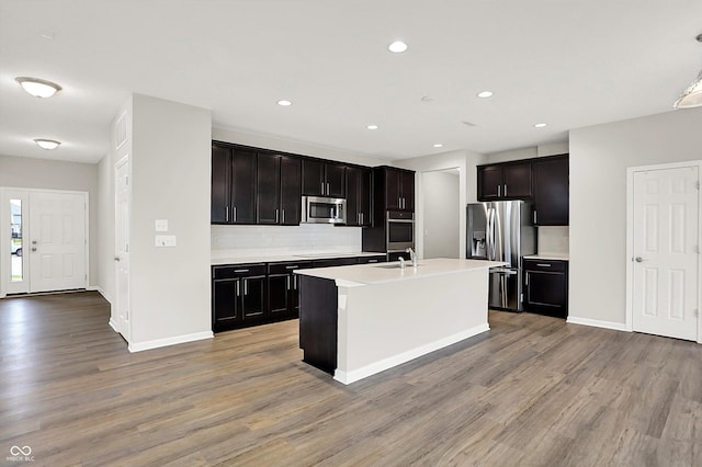 6762 Brentwood Ct, Brownsburg, IN 46112 - kitchen featuring stainless steel appliances, light wood finished floors, decorative backsplash, light countertops, and recessed lighting