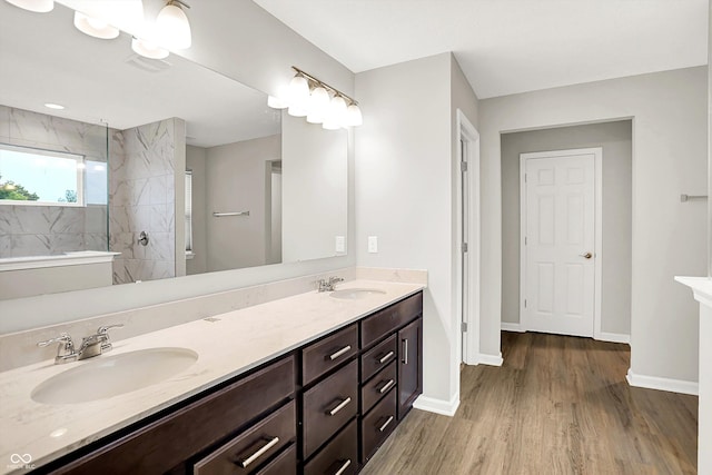 6762 Brentwood Ct, Brownsburg, IN 46112 - full bathroom featuring double vanity, wood finished floors, a walk in shower, and baseboards