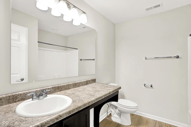 6762 Brentwood Ct, Brownsburg, IN 46112 - full bath featuring wood finished floors, a shower, baseboards, vanity, and toilet