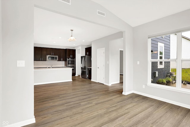 6762 Brentwood Ct, Brownsburg, IN 46112 - kitchen with appliances with stainless steel finishes, open floor plan, dark brown cabinets, light wood finished floors, and baseboards