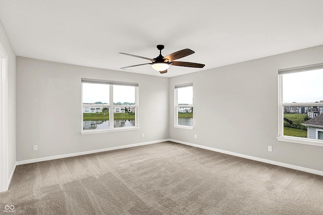 6762 Brentwood Ct, Brownsburg, IN 46112 - empty room with carpet flooring, ceiling fan, baseboards, and a water view