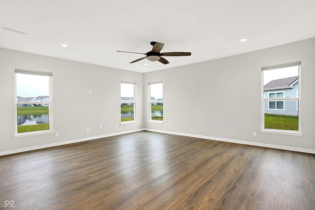 6762 Brentwood Ct, Brownsburg, IN 46112 - unfurnished room with plenty of natural light, dark wood-style floors, a ceiling fan, baseboards, and recessed lighting