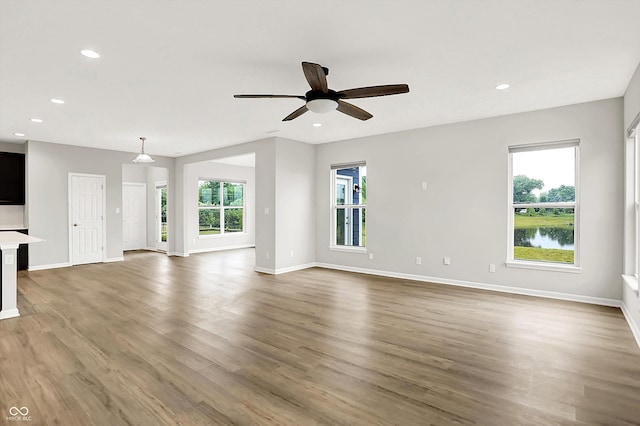 6762 Brentwood Ct, Brownsburg, IN 46112 - unfurnished living room with ceiling fan, wood finished floors, baseboards, and recessed lighting