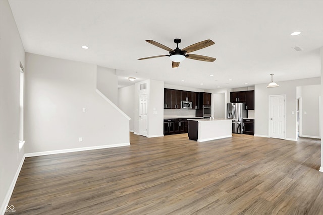 6762 Brentwood Ct, Brownsburg, IN 46112 - unfurnished living room with ceiling fan, baseboards, wood finished floors, recessed lighting, and stairs