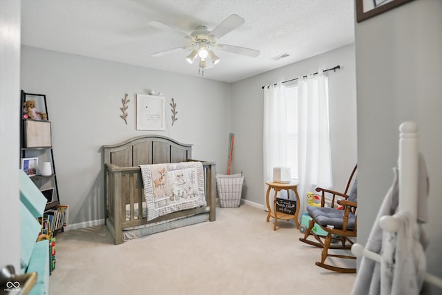 2145 W Autumn Ln, Columbus, IN 47201 - carpeted bedroom with a crib, a ceiling fan, and baseboards