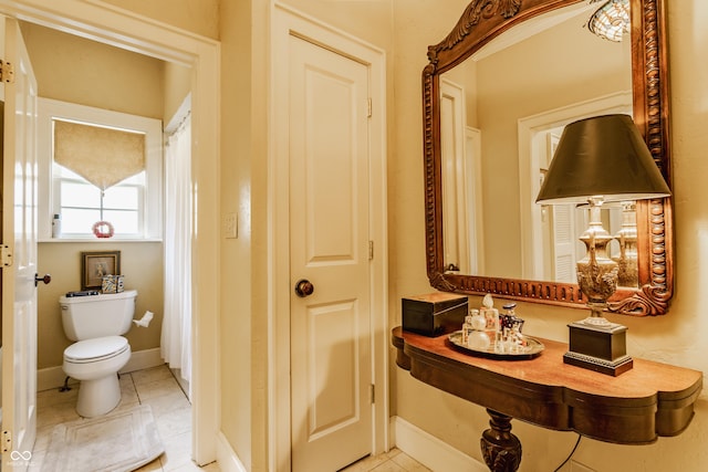 224 N Pennsylvania St, Greenfield, IN 46140 - bathroom featuring toilet, tile patterned floors, and baseboards