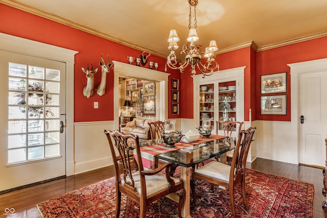 224 N Pennsylvania St, Greenfield, IN 46140 - dining space featuring a chandelier, a wainscoted wall, dark wood finished floors, healthy amount of natural light, and crown molding