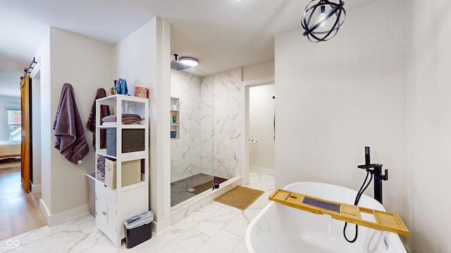 615 Orange St, Indianapolis, IN 46203 - full bath with marble look tile flooring, a marble finish shower, a freestanding bath, and baseboards