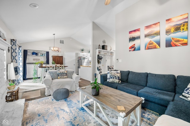 6933 Grey Wolf Dr, Hamblen Township, IN 46164 - living room featuring lofted ceiling, heating unit, and a chandelier