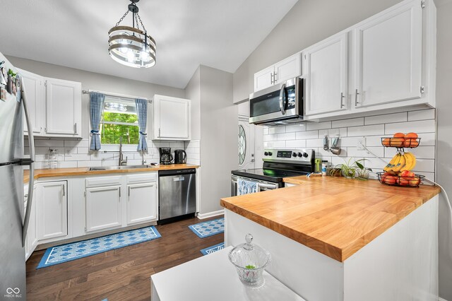 6933 Grey Wolf Dr, Hamblen Township, IN 46164 - kitchen with appliances with stainless steel finishes, butcher block counters, dark wood-style floors, white cabinets, and lofted ceiling