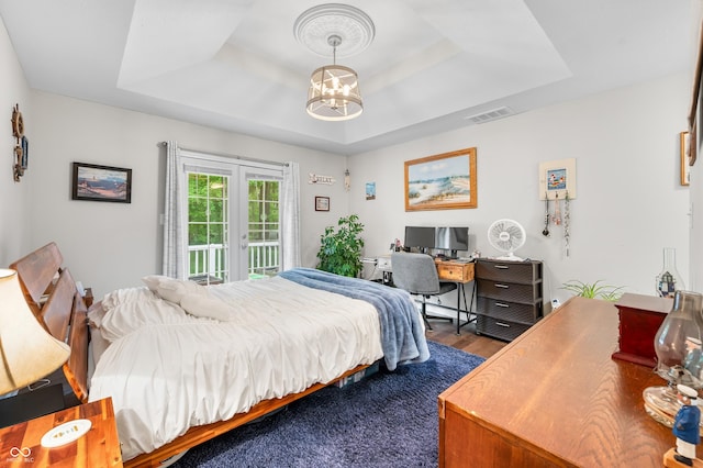 6933 Grey Wolf Dr, Hamblen Township, IN 46164 - bedroom featuring a raised ceiling, dark wood finished floors, french doors, an office area, and access to exterior
