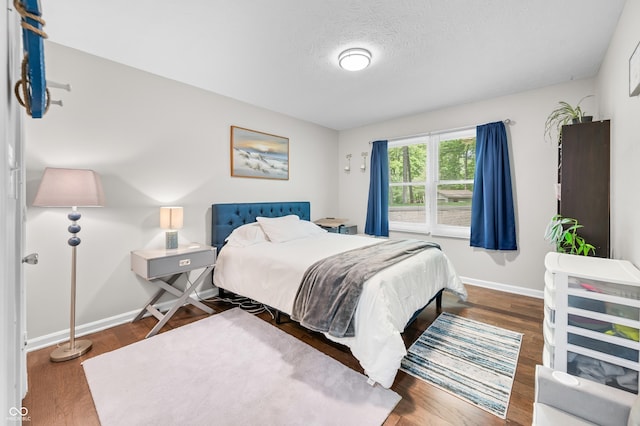 6933 Grey Wolf Dr, Hamblen Township, IN 46164 - bedroom featuring wood finished floors, baseboards, and a textured ceiling