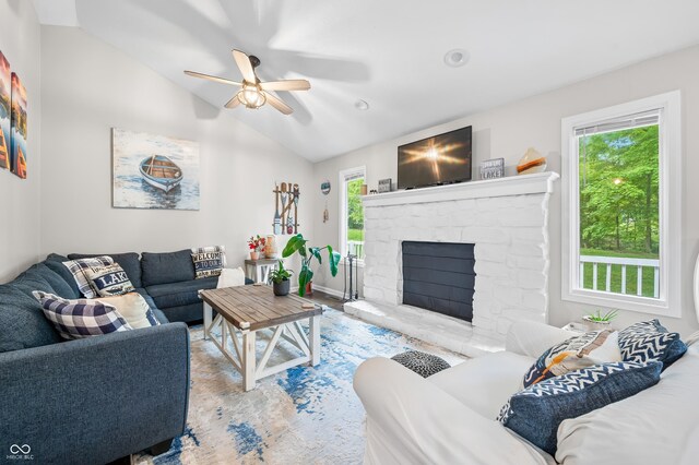 6933 Grey Wolf Dr, Hamblen Township, IN 46164 - living area featuring ceiling fan, lofted ceiling, a fireplace, wood finished floors, and baseboards