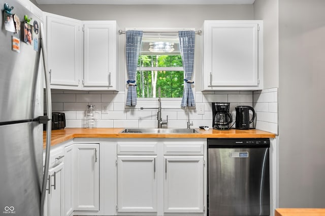 6933 Grey Wolf Dr, Hamblen Township, IN 46164 - kitchen with appliances with stainless steel finishes, a sink, white cabinets, and tasteful backsplash