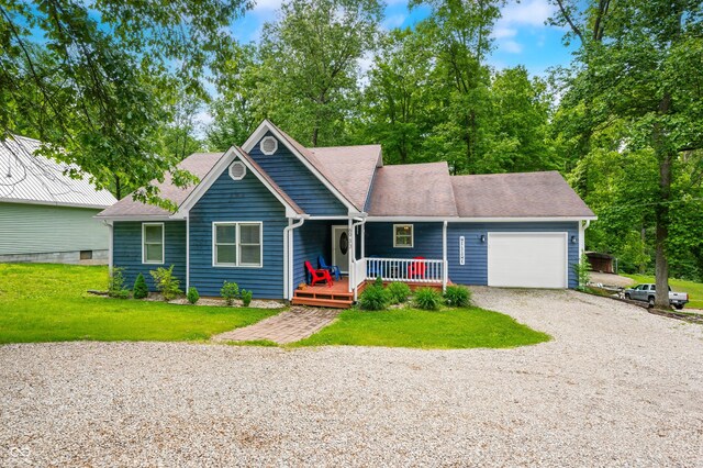 6933 Grey Wolf Dr, Hamblen Township, IN 46164 - ranch-style home featuring an attached garage, gravel driveway, covered porch, a front yard, and a shingled roof