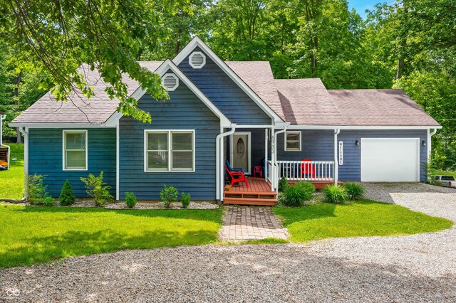 6933 Grey Wolf Dr, Hamblen Township, IN 46164 - single story home with an attached garage, gravel driveway, a front lawn, covered porch, and a shingled roof