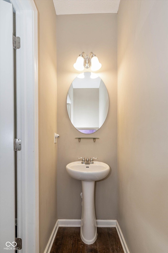 5767 Bluff View Ln, Whitestown, IN 46075 - bathroom featuring baseboards and wood finished floors
