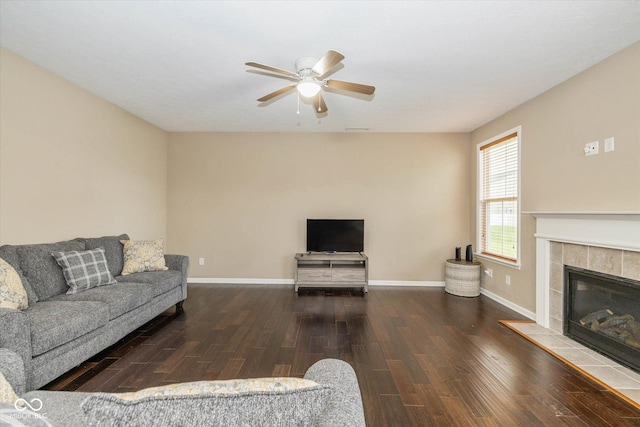 5767 Bluff View Ln, Whitestown, IN 46075 - living room with wood finished floors, ceiling fan, a tiled fireplace, and baseboards