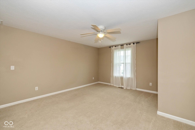 5767 Bluff View Ln, Whitestown, IN 46075 - spare room featuring a ceiling fan, light carpet, and baseboards