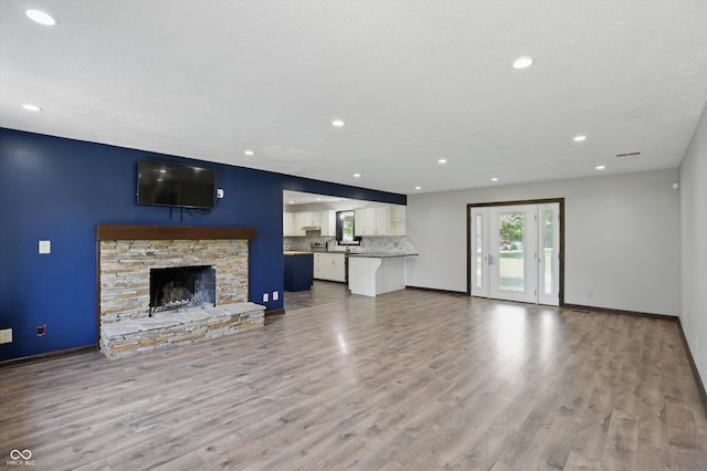 8510 N Carroll Rd, Indianapolis, IN 46236 - unfurnished living room featuring wood finished floors, baseboards, a fireplace, and recessed lighting