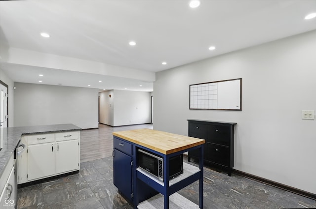 8510 N Carroll Rd, Indianapolis, IN 46236 - kitchen featuring white cabinets, wooden counters, recessed lighting, stainless steel dishwasher, and baseboards