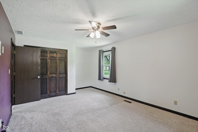 8510 N Carroll Rd, Indianapolis, IN 46236 - unfurnished bedroom with carpet, a closet, baseboards, a ceiling fan, and a textured ceiling