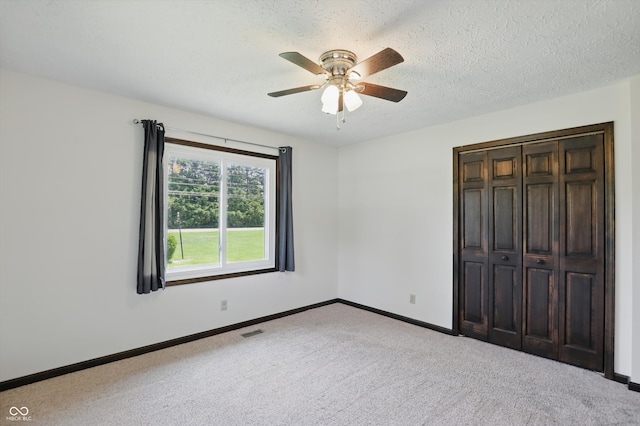 8510 N Carroll Rd, Indianapolis, IN 46236 - unfurnished bedroom featuring baseboards, carpet floors, a closet, ceiling fan, and a textured ceiling