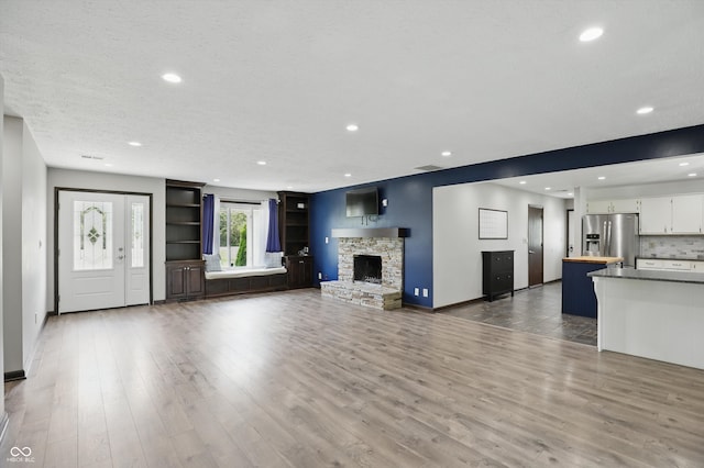 8510 N Carroll Rd, Indianapolis, IN 46236 - unfurnished living room with wood finished floors, recessed lighting, baseboards, and a fireplace