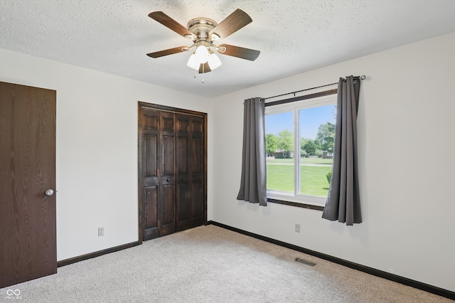 8510 N Carroll Rd, Indianapolis, IN 46236 - unfurnished bedroom with light carpet, a closet, baseboards, a textured ceiling, and a ceiling fan
