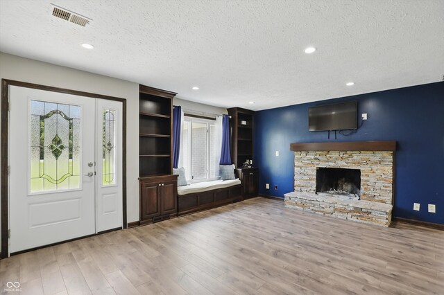 8510 N Carroll Rd, Indianapolis, IN 46236 - entrance foyer featuring a textured ceiling, healthy amount of natural light, wood finished floors, a stone fireplace, and recessed lighting
