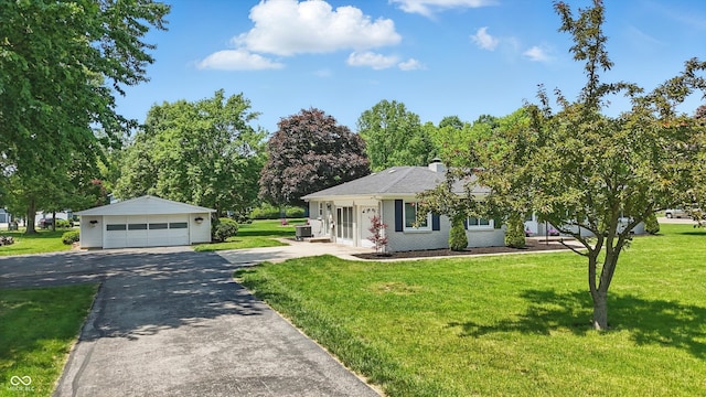 8510 N Carroll Rd, Indianapolis, IN 46236 - view of front of property featuring a garage, an outbuilding, a front yard, and a chimney