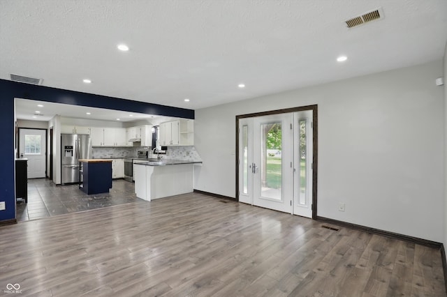 8510 N Carroll Rd, Indianapolis, IN 46236 - kitchen with stainless steel appliances, white cabinetry, dark wood-style floors, decorative backsplash, and open shelves