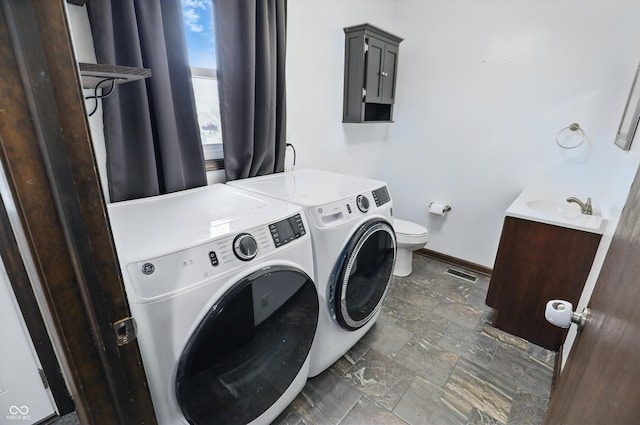 8510 N Carroll Rd, Indianapolis, IN 46236 - washroom featuring washer and clothes dryer, baseboards, and stone finish flooring