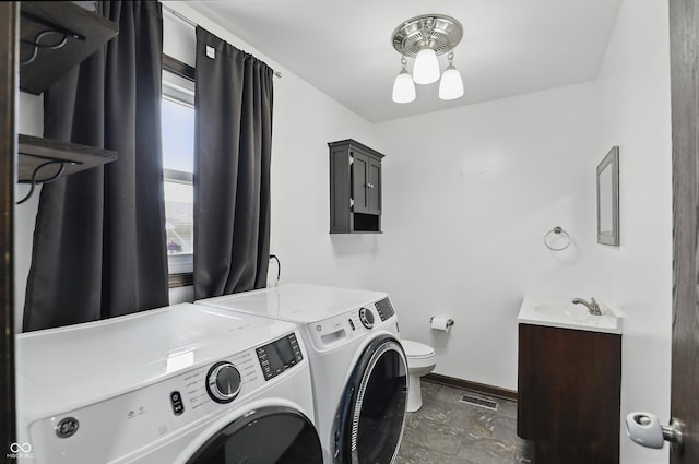 8510 N Carroll Rd, Indianapolis, IN 46236 - washroom featuring separate washer and dryer, baseboards, and stone finish floors