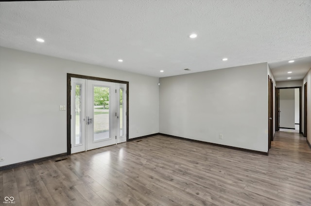 8510 N Carroll Rd, Indianapolis, IN 46236 - spare room with a textured ceiling, recessed lighting, wood finished floors, and baseboards