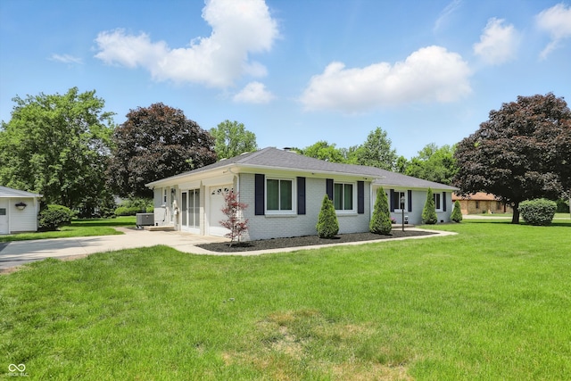 8510 N Carroll Rd, Indianapolis, IN 46236 - ranch-style home featuring driveway, brick siding, a garage, a front yard, and cooling unit